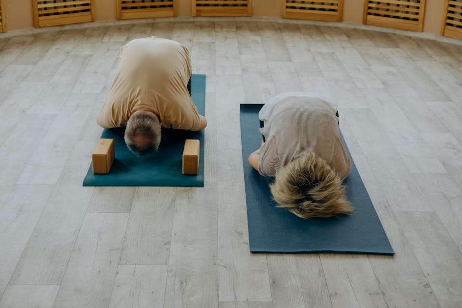 Diverse group of people practicing a standing yoga pose in a bright studio